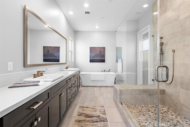 bathroom featuring separate shower and tub and vanity