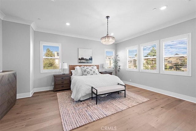 bedroom featuring ornamental molding and light hardwood / wood-style floors