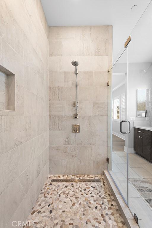 bathroom featuring vanity and a shower with shower door