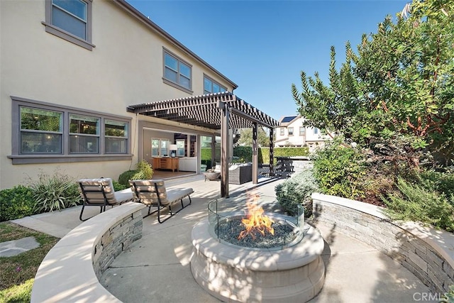 view of patio / terrace featuring a pergola and a fire pit