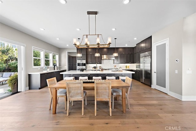 dining room featuring a notable chandelier and light wood-type flooring