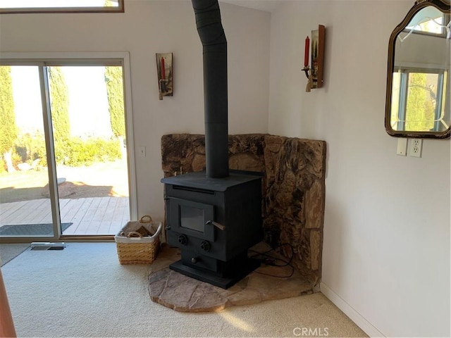 room details featuring a wood stove and carpet