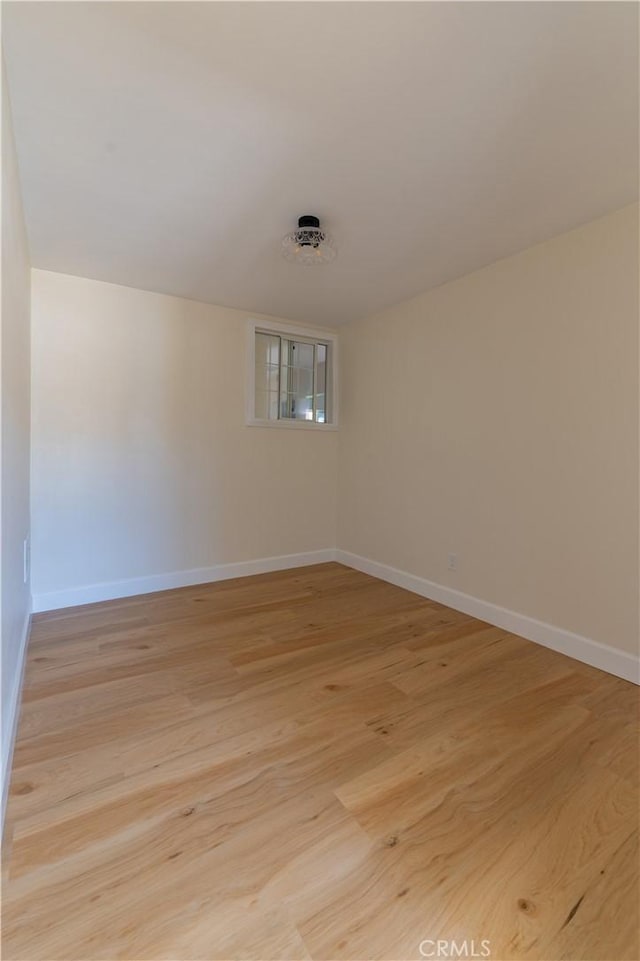 spare room with light hardwood / wood-style flooring