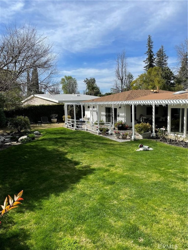 rear view of house with a lawn