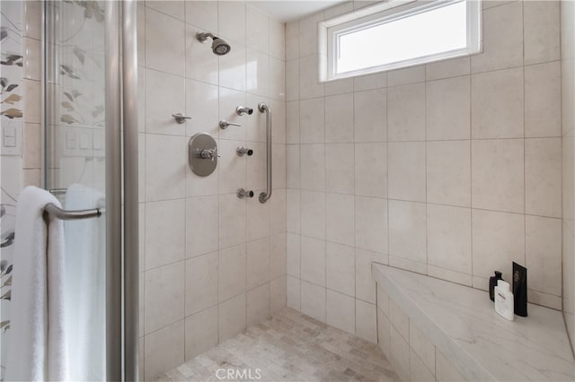 bathroom with tiled shower