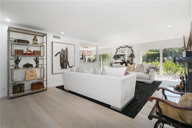 living room featuring light wood-type flooring and plenty of natural light