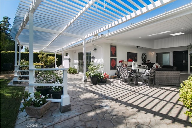 view of patio featuring an outdoor living space and a pergola