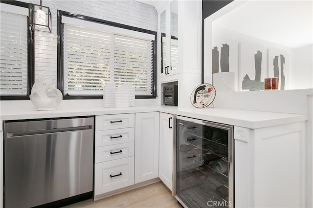 bar featuring wine cooler, light wood-type flooring, white cabinetry, and dishwasher