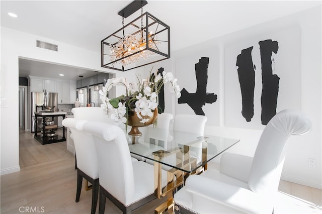 dining space with light hardwood / wood-style flooring