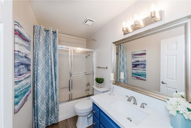 full bathroom featuring toilet, vanity, shower / bath combination with glass door, and wood-type flooring