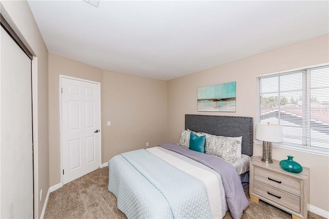 bedroom featuring a closet and light colored carpet