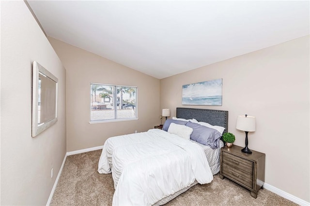 carpeted bedroom with lofted ceiling