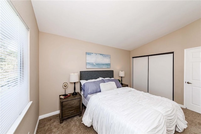 bedroom featuring carpet floors, a closet, and lofted ceiling