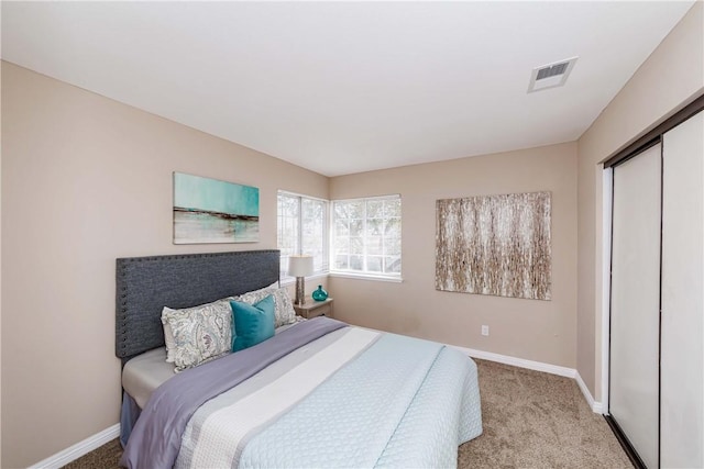 bedroom featuring a closet and light colored carpet