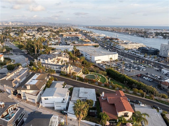 birds eye view of property with a water view and a city view