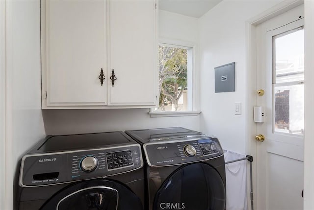 laundry room with cabinet space and washer and clothes dryer