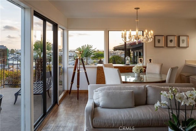 sunroom with plenty of natural light and a notable chandelier