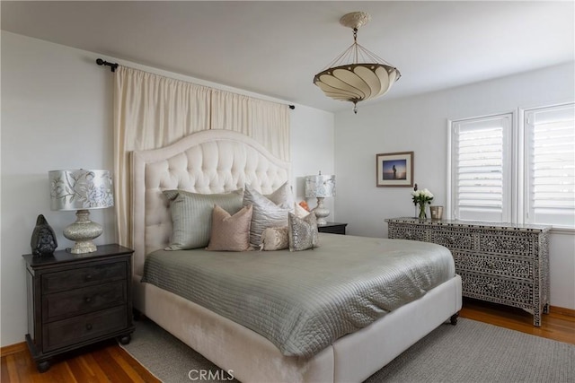 bedroom with dark wood-style floors