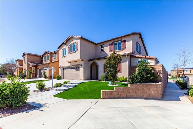 mediterranean / spanish-style house featuring a residential view, a tile roof, stucco siding, driveway, and an attached garage