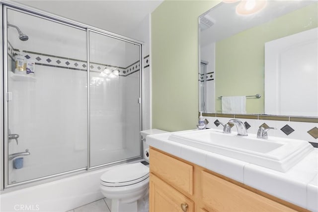 full bathroom with toilet, tile patterned flooring, vanity, and enclosed tub / shower combo