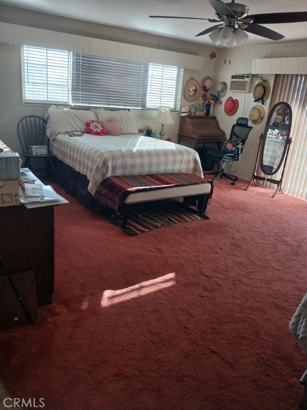 bedroom featuring a wall mounted air conditioner, ceiling fan, and carpet flooring