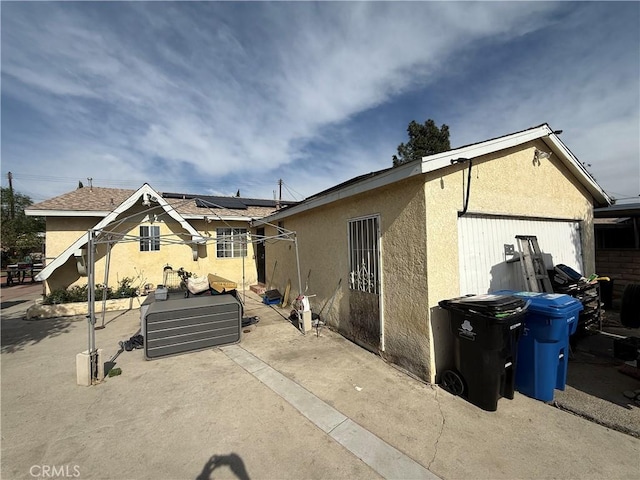 view of property exterior featuring solar panels