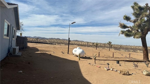 view of yard with ac unit and a mountain view