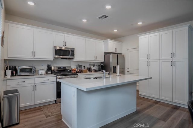 kitchen featuring white cabinetry, a center island with sink, appliances with stainless steel finishes, and sink