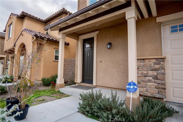 view of exterior entry featuring a garage