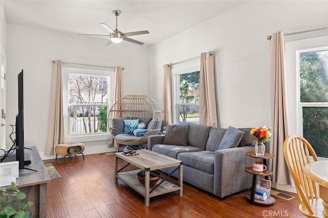 living room featuring wood-type flooring and ceiling fan