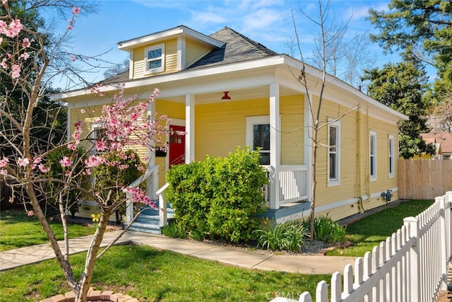 bungalow-style house featuring a porch and fence