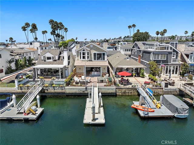 view of dock featuring a water view and a residential view