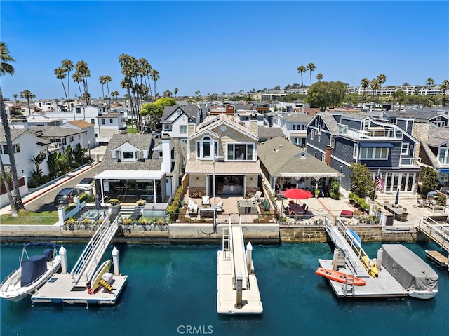 back of house featuring a water view and a residential view