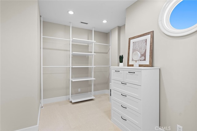 spacious closet with light carpet and visible vents