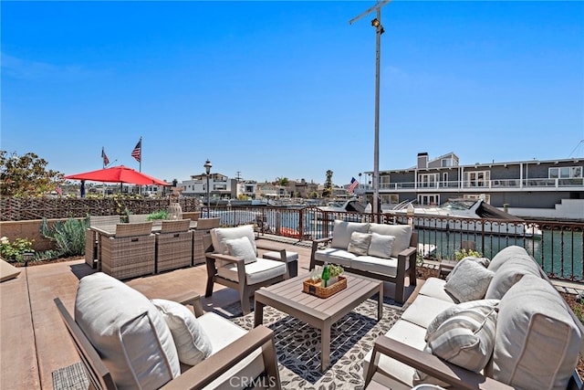 view of patio / terrace with a water view and outdoor lounge area