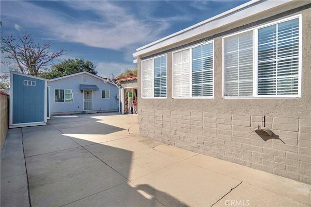 view of side of home featuring a patio