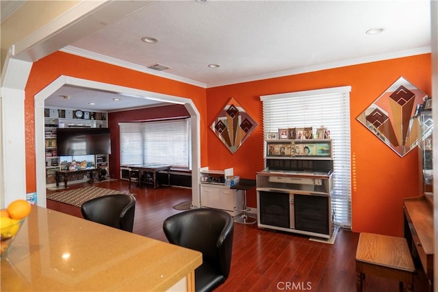 office space featuring dark hardwood / wood-style flooring, ornamental molding, and built in shelves