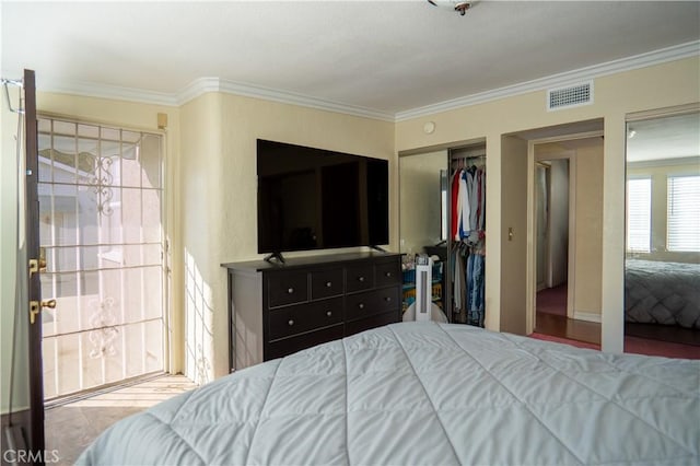 bedroom featuring ornamental molding and a closet