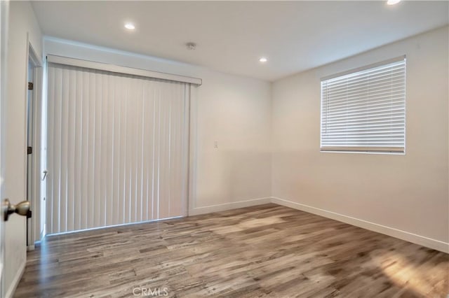 unfurnished room with hardwood / wood-style floors