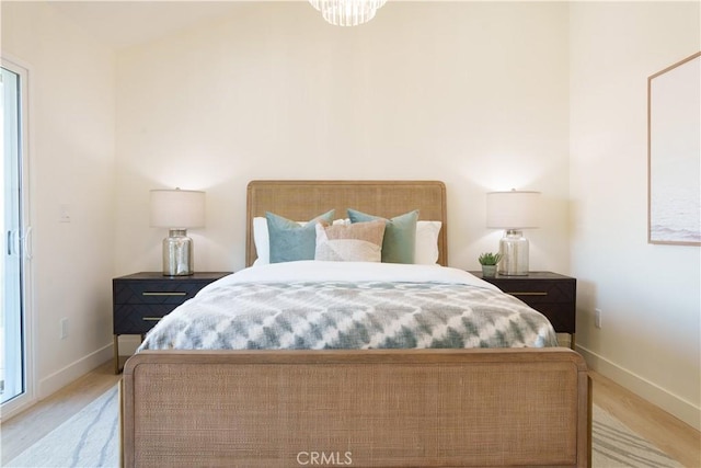 bedroom featuring baseboards and light wood-style flooring