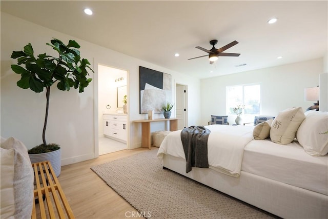 bedroom featuring a ceiling fan, visible vents, recessed lighting, light wood-style floors, and connected bathroom