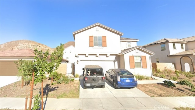 view of front of property with a garage and a mountain view