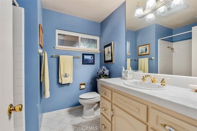 bathroom with toilet, vanity, baseboards, tile patterned floors, and walk in shower