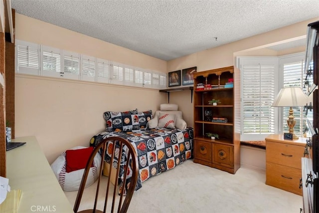 bedroom featuring light carpet and a textured ceiling