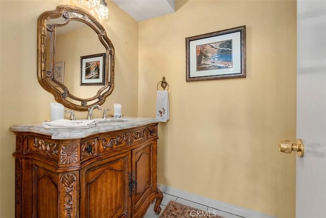 bathroom featuring tile patterned flooring, vanity, and baseboards