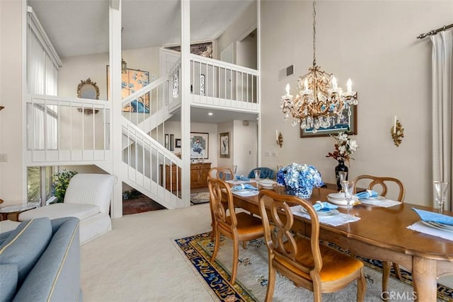 carpeted dining area with a chandelier, high vaulted ceiling, stairway, and plenty of natural light