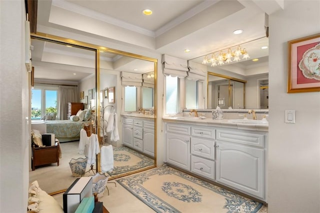 full bathroom featuring ornamental molding, a raised ceiling, connected bathroom, and a sink