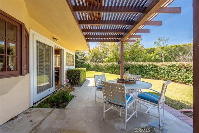 view of patio / terrace with outdoor dining area, fence, and a pergola