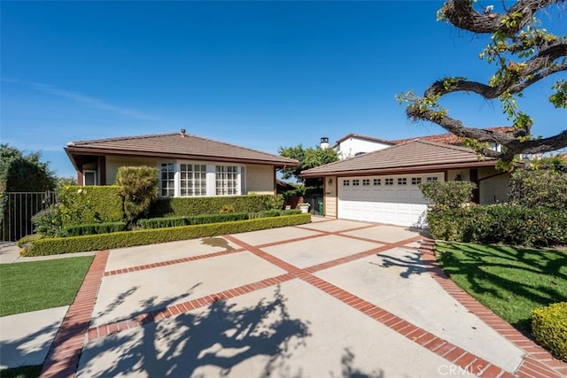 view of front of house featuring a tile roof, driveway, and a front lawn