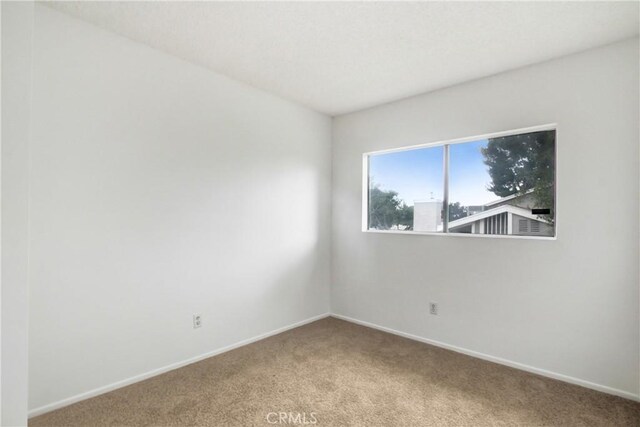 2061 W Redlands Blvd Unit 8C, Redlands, CA 92373 - carpeted spare room featuring baseboards